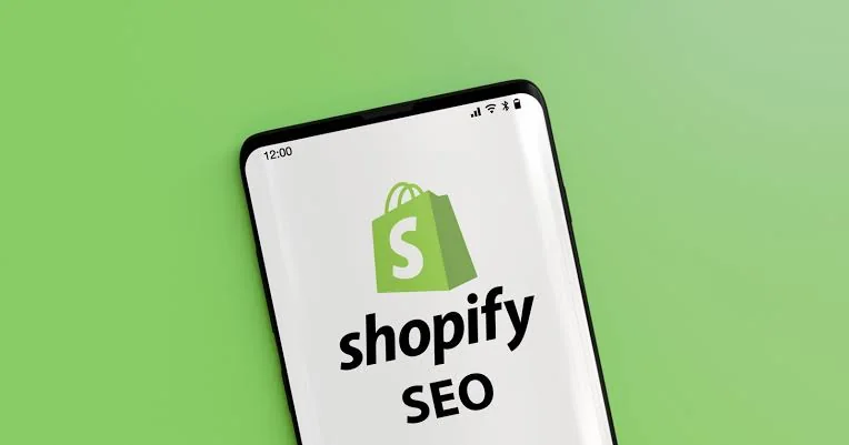 Jasa SEO Shopify — logo Shopify SEO tampil di layar ponsel, menandakan optimasi toko Shopify untuk pencarian mobile